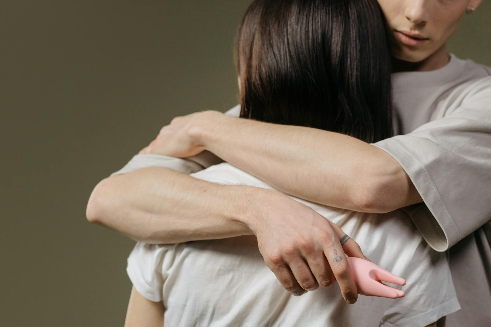 Close-up of a couple embracing in an intimate moment, showing physical connection and vulnerability.