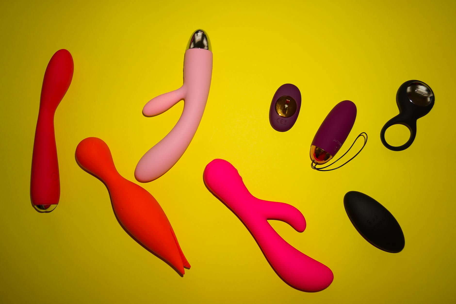 A blue silicone sex toy held in hand against a purple background, promoting self-love and sexuality